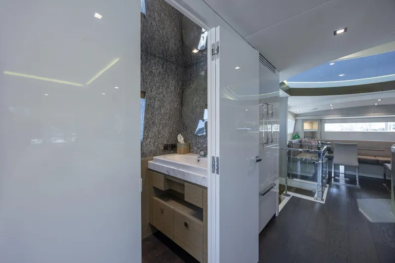 Slide: The Image of Luxurious interior of 2017 Hatteras M75 Panacera yacht, featuring modern bathroom and spacious living area. - 36