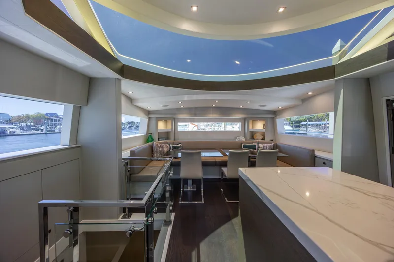 Slide: The Image of Luxurious interior of 2017 Hatteras M75 Panacera yacht with modern seating and panoramic windows. - 46
