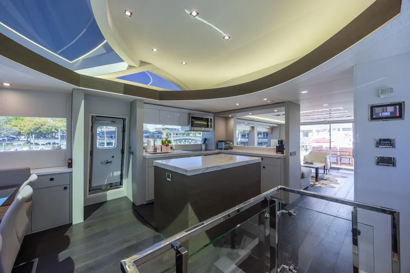 Slide: The Image of Luxurious interior of 2017 Hatteras M75 Panacera yacht with modern kitchen and seating area. - 47