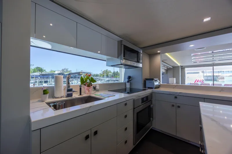 Slide: The Image of Modern kitchen interior on 2017 Hatteras M75 Panacera yacht with sleek cabinetry and appliances. - 51