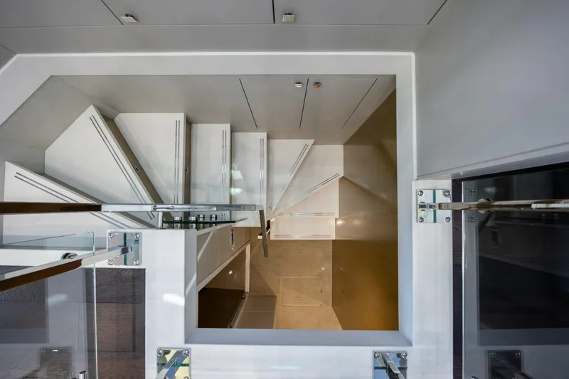 Slide: The Image of Interior staircase of 2017 Hatteras M75 Panacera yacht, featuring modern design and glass railings. - 54