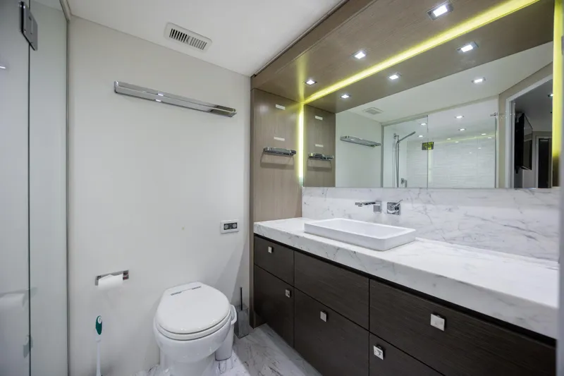 Slide: The Image of Luxurious bathroom in 2017 Hatteras M75 Panacera yacht with modern fixtures and marble countertop. - 62