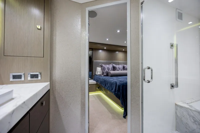 Slide: The Image of Luxurious interior of 2017 Hatteras M75 Panacera yacht, featuring elegant bedroom and bathroom. - 63