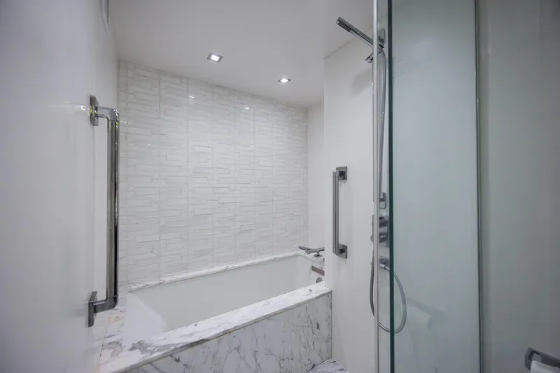 Slide: The Image of Luxurious bathroom with marble accents in 2017 Hatteras M75 Panacera yacht. - 64