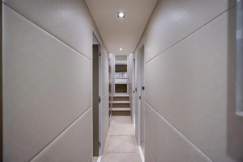 Slide: The Image of Luxurious hallway inside 2017 Hatteras M75 Panacera yacht, featuring modern design and soft lighting. - 66