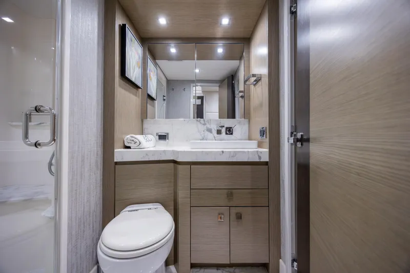 Slide: The Image of Luxurious bathroom in 2017 Hatteras M75 Panacera yacht with modern fixtures and marble countertop. - 71