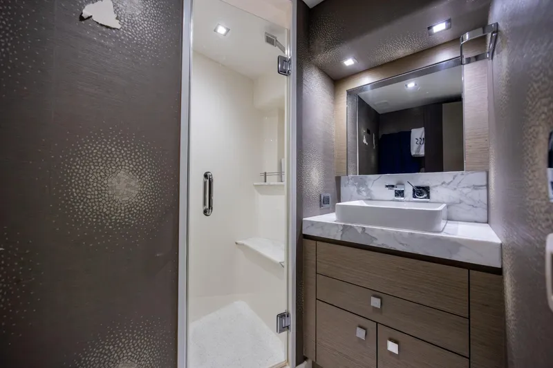 Slide: The Image of Luxurious bathroom in 2017 Hatteras M75 Panacera yacht with modern fixtures and elegant design. - 76