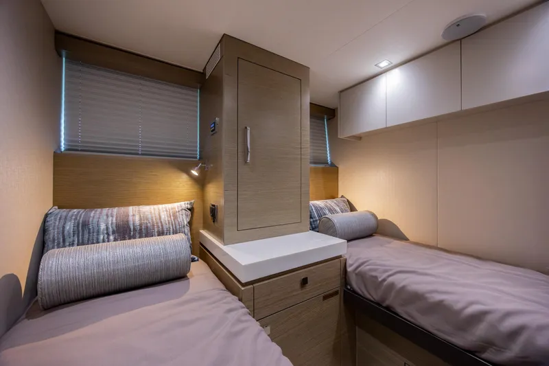 Slide: The Image of Interior of 2017 Hatteras M75 Panacera yacht with twin beds and modern decor. - 79