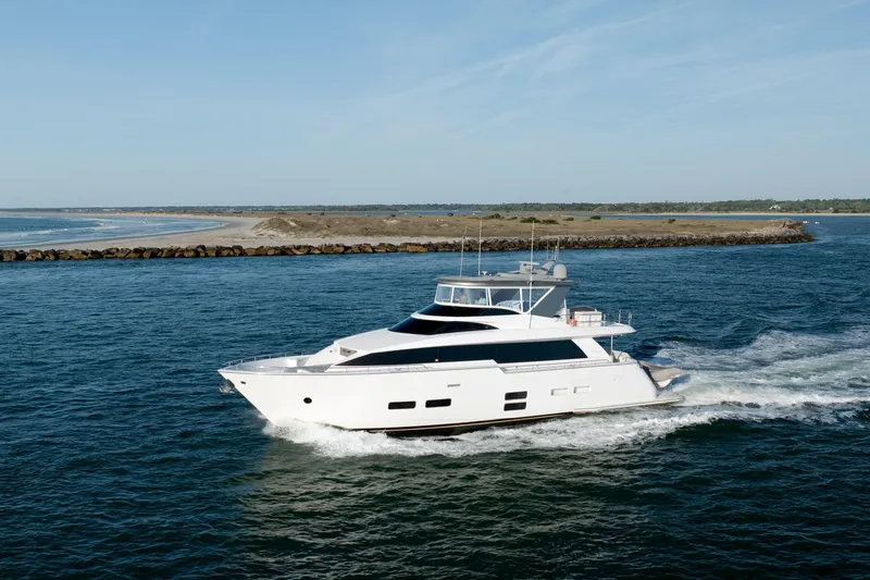 Slide: The Image of Luxury 2017 Hatteras M75 Panacera yacht cruising near a scenic coastline. - 8