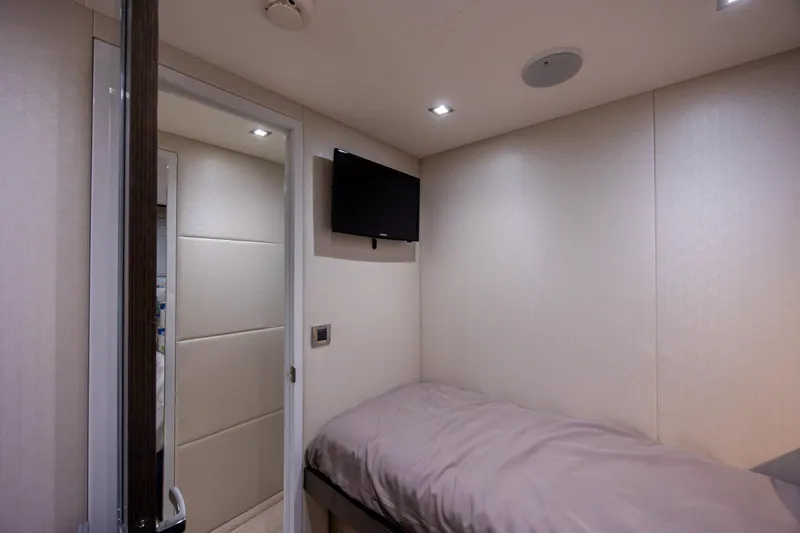 Slide: The Image of Small cabin interior of 2017 Hatteras M75 Panacera yacht with bed and wall-mounted TV. - 80