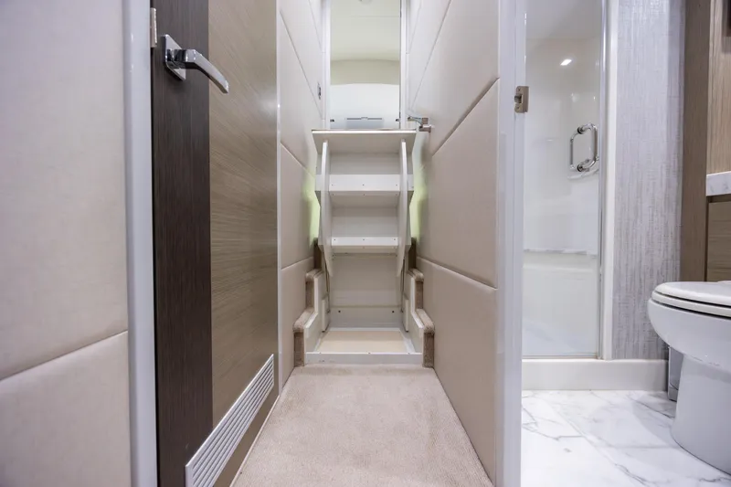 Slide: The Image of Interior of 2017 Hatteras M75 Panacera yacht, featuring a compact staircase and modern bathroom. - 81