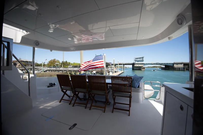 Slide: The Image of Luxurious 2017 Hatteras M75 Panacera yacht deck with seating and ocean view. - 82