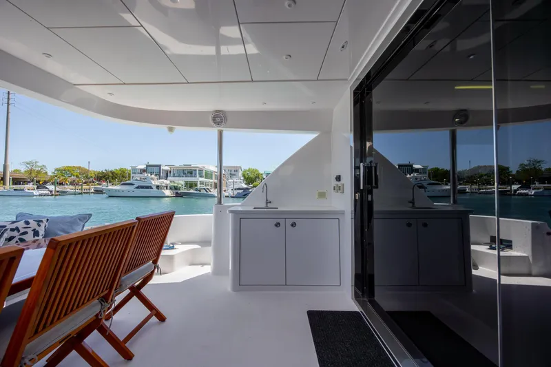 Slide: The Image of Luxurious 2017 Hatteras M75 Panacera yacht deck with seating and waterfront view. - 83