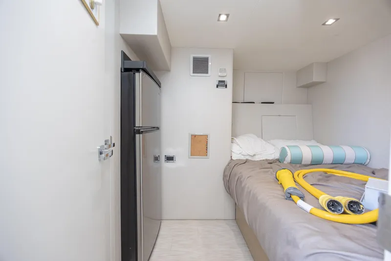 Slide: The Image of Interior cabin of 2017 Hatteras M75 Panacera yacht with bed and mini fridge. - 87