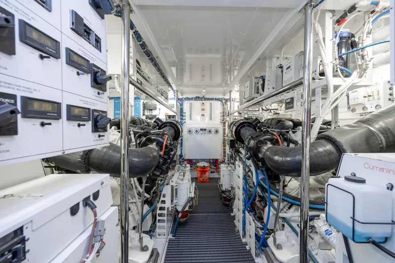Slide: The Image of Engine room of 2017 Hatteras M75 Panacera yacht, showcasing complex machinery and control panels. - 89