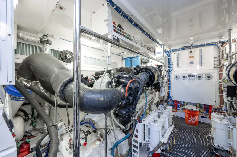 Slide: The Image of Engine room of 2017 Hatteras M75 Panacera yacht, showcasing complex machinery and systems. - 90