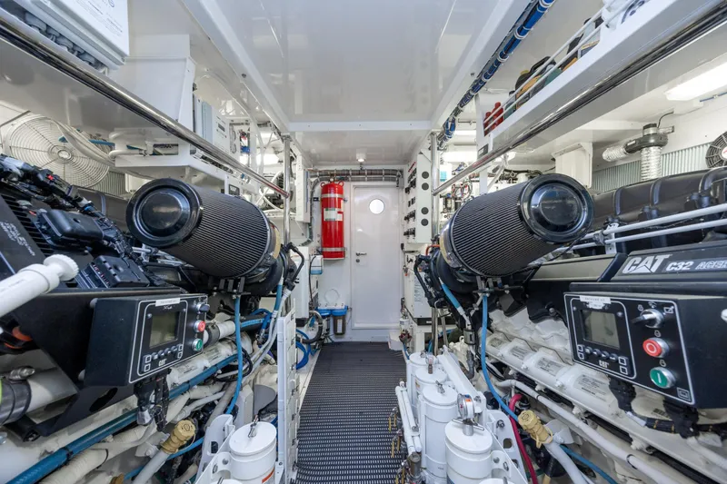 Slide: The Image of Engine room of 2017 Hatteras M75 Panacera yacht, featuring dual CAT C32 engines. - 93