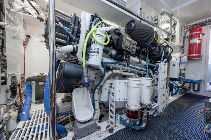 Slide: The Image of Engine room of 2017 Hatteras M75 Panacera yacht, showcasing complex machinery and equipment. - 95