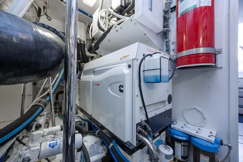 Slide: The Image of Engine room of 2017 Hatteras M75 Panacera yacht with Cummins Onan generator and fire extinguisher. - 96