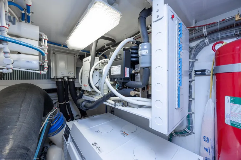 Slide: The Image of Engine room of 2017 Hatteras M75 Panacera yacht with mechanical equipment and piping. - 99