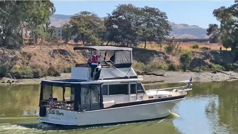 The Image of 1984 Californian LRC boat cruising on a river. - 0