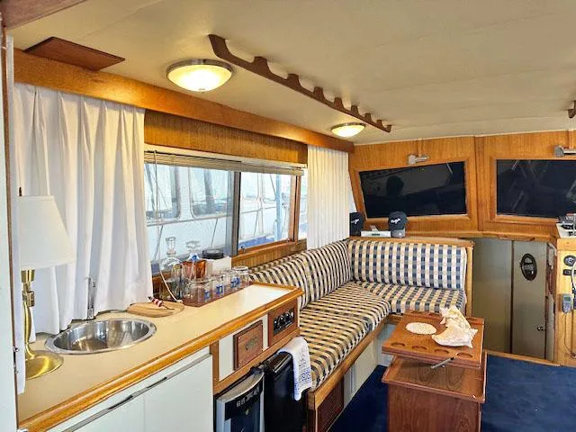 Slide: The Image of Interior of a 1984 Californian LRC yacht with cozy seating and kitchenette. - 10