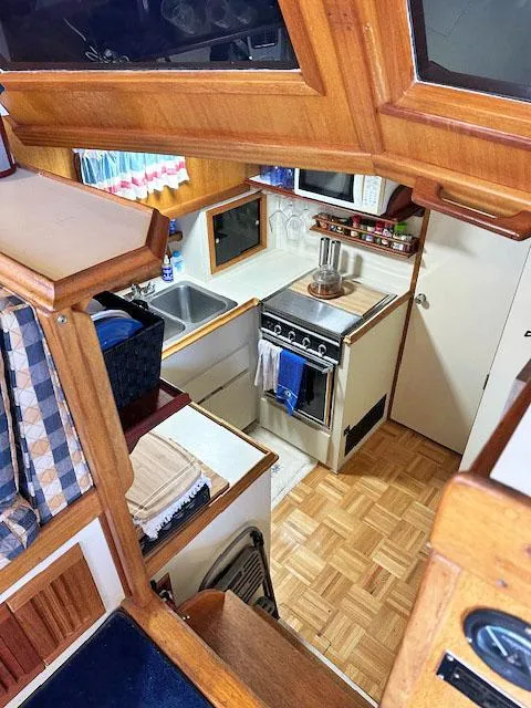 Slide: The Image of Interior of a 1984 Californian LRC yacht kitchen with wood paneling. - 12