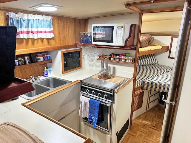 Slide: The Image of Interior of a 1984 Californian LRC yacht with kitchen and sleeping area. - 14