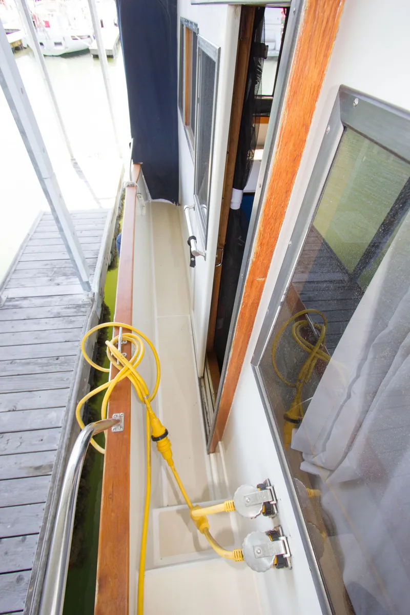 Slide: The Image of Side deck of a 1984 Californian LRC yacht with yellow cable. - 29