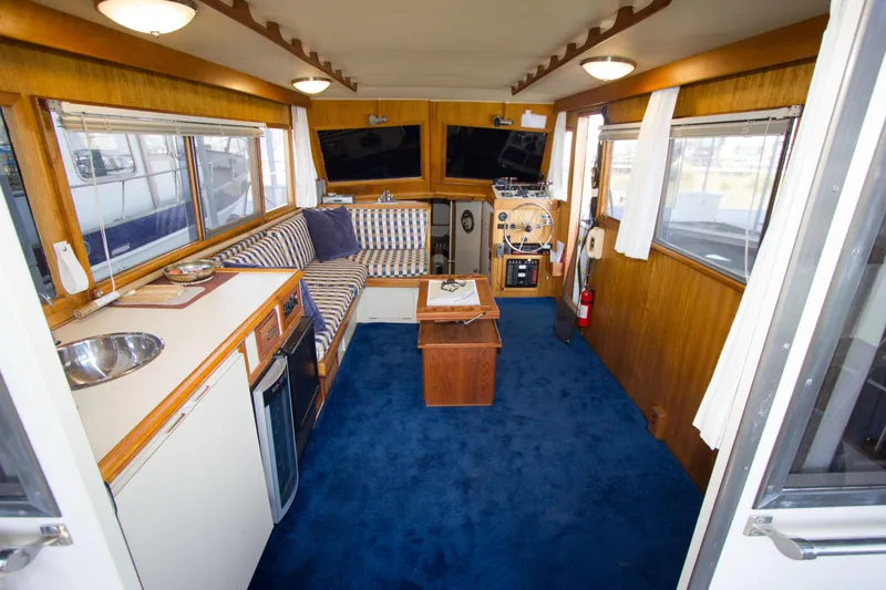 Slide: The Image of Interior of a 1984 Californian LRC yacht with blue carpet flooring. - 6