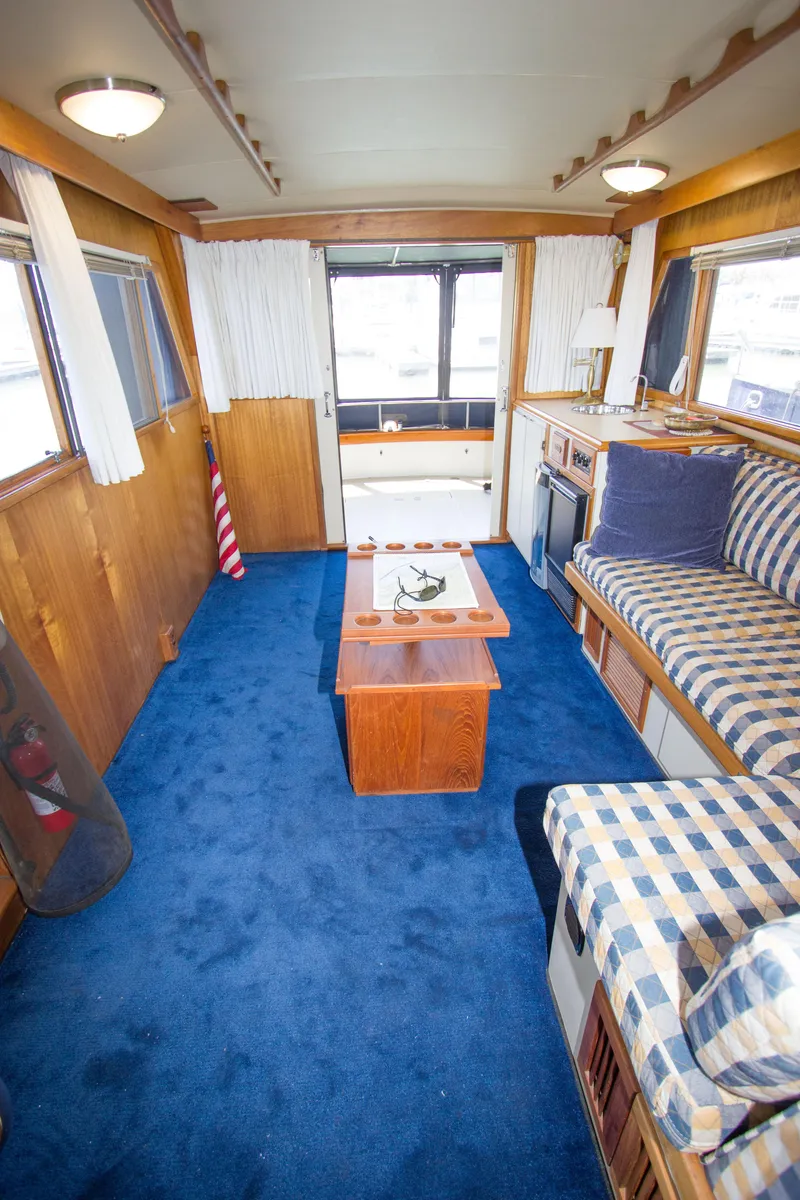 Slide: The Image of Interior of a 1984 Californian LRC yacht with blue carpet flooring. - 9