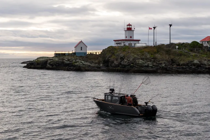 Slide: The Image of Jasper Marine Defender 22 boat near lighthouse, 2026 model. - 10