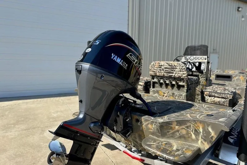 Slide: The Image of 2026 War Eagle 961 Blackhawk boat with Yamaha outboard motor, camo seats, and control panel. - 10