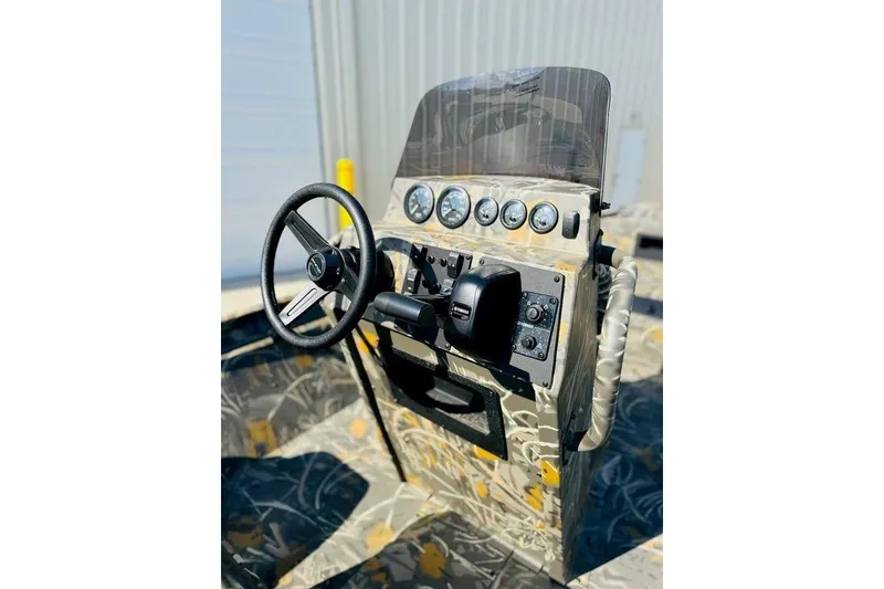 Slide: The Image of 2026 War Eagle 961 Blackhawk boat console with steering wheel and gauges. - 3