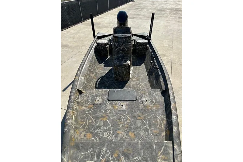 Slide: The Image of 2026 War Eagle 961 Blackhawk boat with camouflage design on a concrete surface. - 7