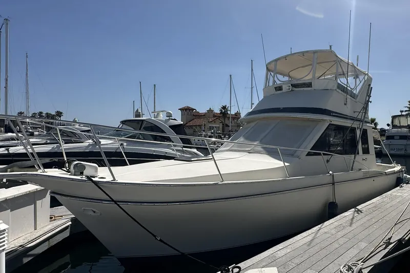 The Image of 1987 Californian 34 yacht docked at marina under clear blue sky. - 0