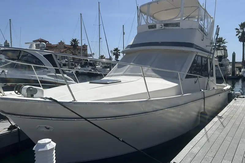 Slide: The Image of 1987 Californian 34 yacht docked at marina with clear blue sky. - 11