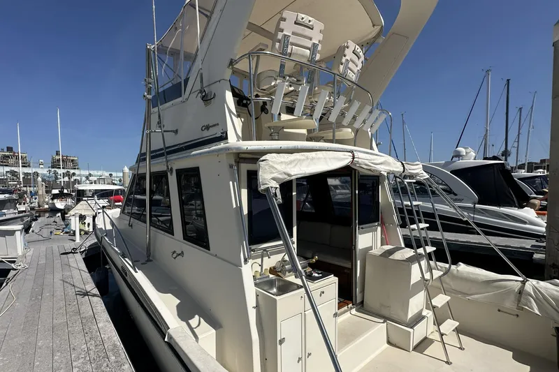 Slide: The Image of 1987 Californian 34 yacht docked at marina under clear blue sky. - 2