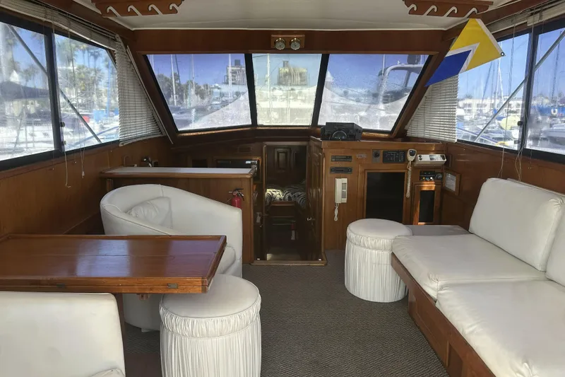Slide: The Image of Interior of a 1987 Californian 34 yacht with white seating and wooden accents. - 5