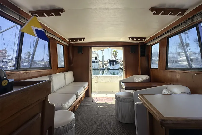 Slide: The Image of Interior of a 1987 Californian 34 yacht with comfortable seating and marina view. - 6