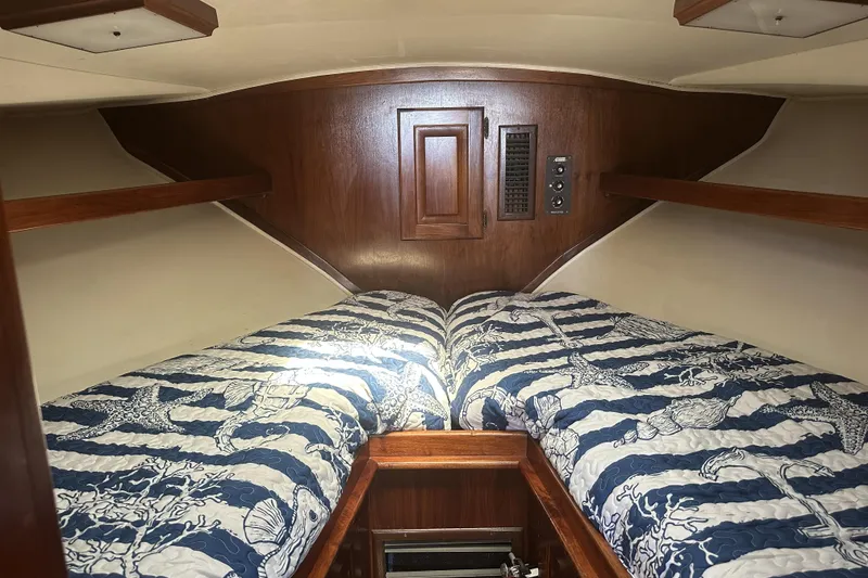 Slide: The Image of Cozy cabin interior of a 1987 Californian 34 boat with twin beds and nautical decor. - 8