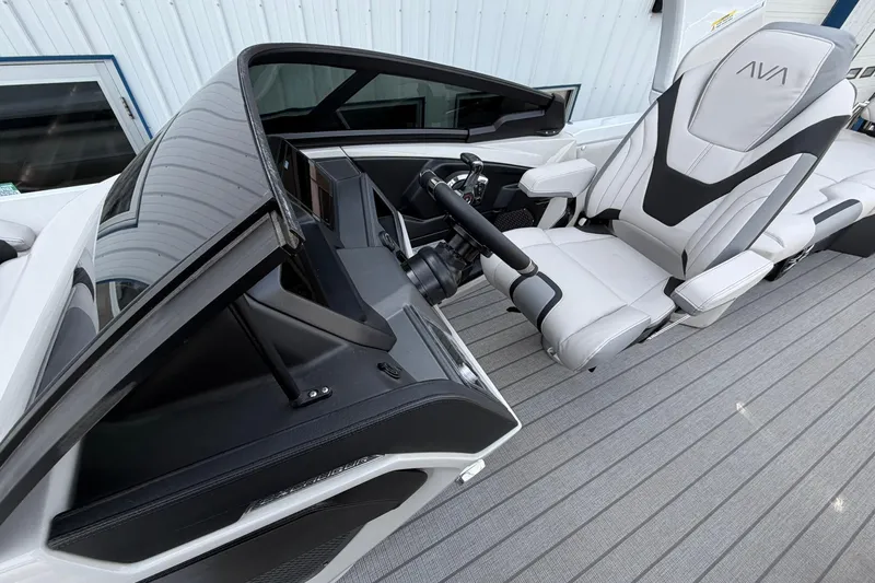 Slide: The Image of 2026 Avalon Excalibur Quad Lounge Windshield boat interior with sleek captain's chair and modern dashboard. - 15