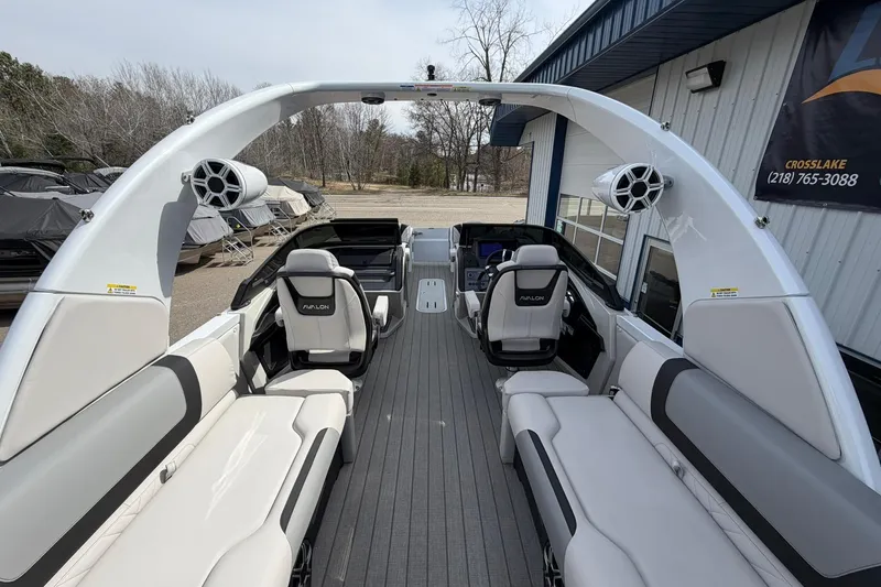 Slide: The Image of 2026 Avalon Excalibur Quad Lounge boat interior with modern seating and sleek design. - 27
