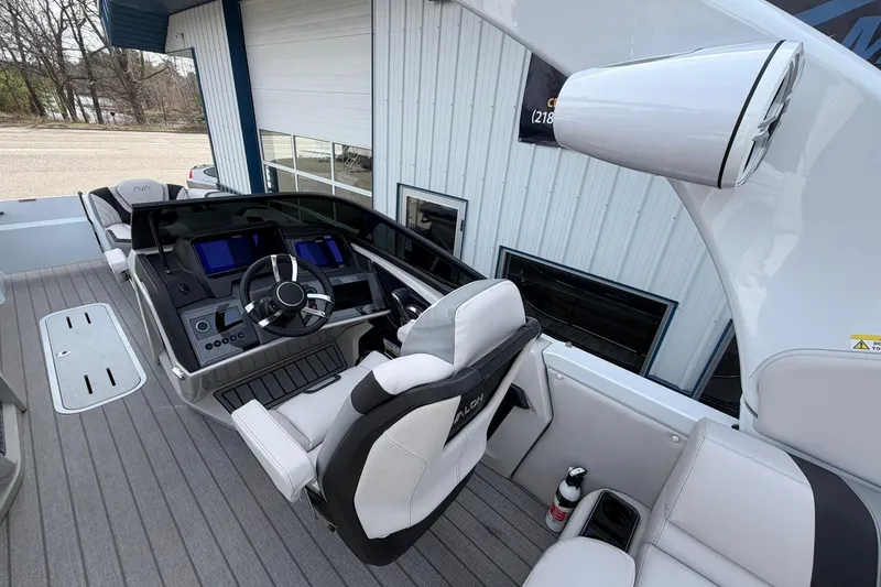 Slide: The Image of 2026 Avalon Excalibur Quad Lounge boat interior with modern dashboard and seating. - 29