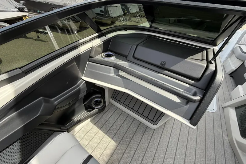Slide: The Image of Interior of 2026 Avalon Excalibur Quad Lounge Windshield boat, featuring sleek seating and cup holders. - 32