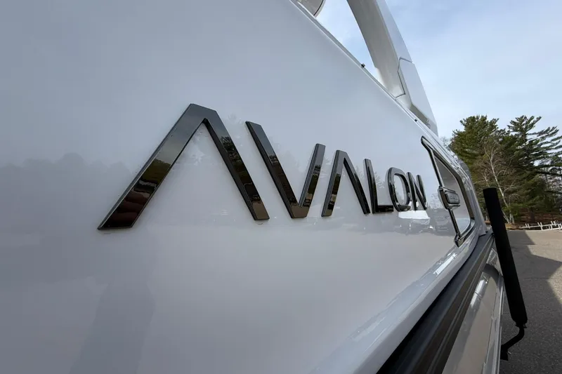 Slide: The Image of 2026 Avalon Excalibur Quad Lounge Windshield boat logo on sleek white surface. - 7