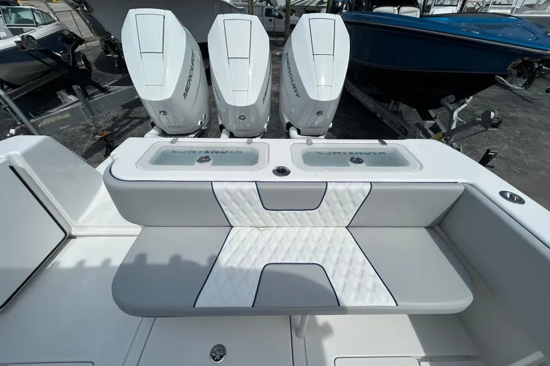 Slide: The Image of 2026 Contender 39 ST boat with triple Mercury engines and cushioned seating. - 10