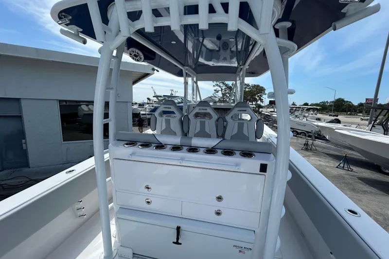 Slide: The Image of 2026 Contender 39 ST boat interior with seating and storage, docked outdoors. - 12