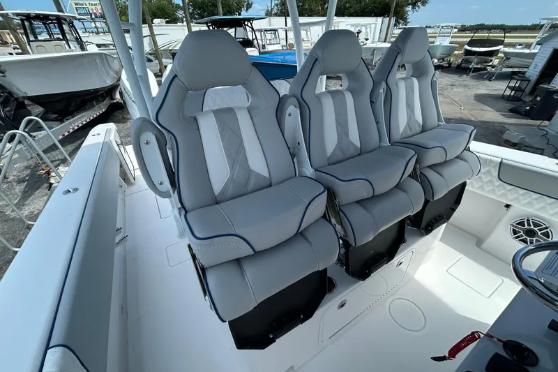 Slide: The Image of 2026 Contender 39 ST boat with three luxurious gray seats in cockpit area. - 16