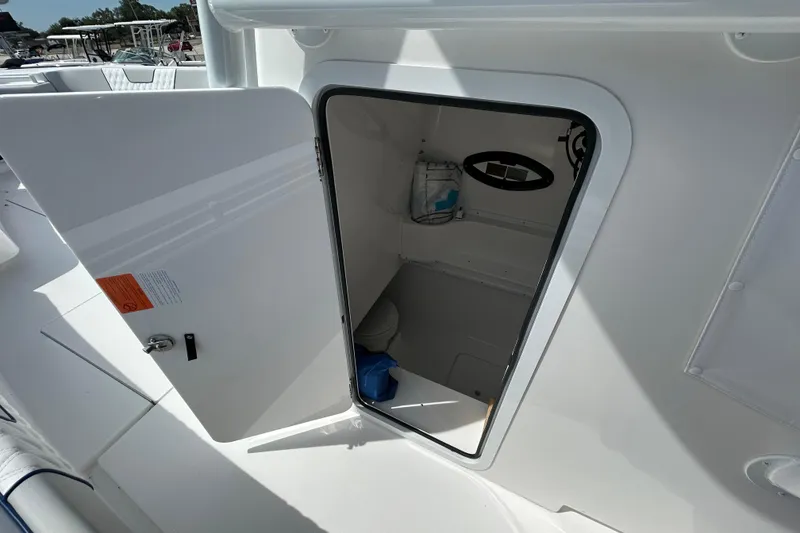 Slide: The Image of 2026 Contender 39 ST boat interior storage compartment with open door, showcasing sleek design. - 18